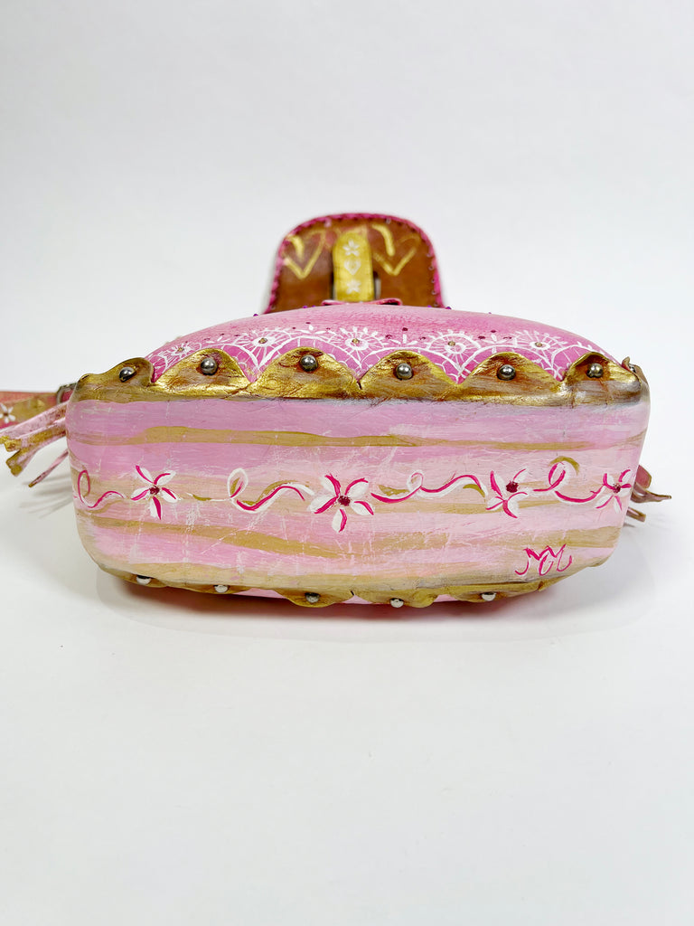 Émilie is a handpainted, up-cycled leather handbag by Mer Rose Atelier, pink is the  main color with ribbons, bows and lace designs.