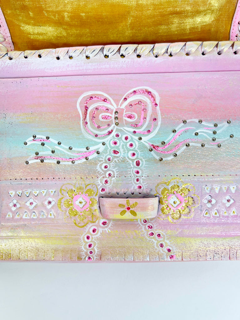 Beautiful hand painted, up-cycled leather handbag in pastel colors with bows by Mer Rose Atelier.