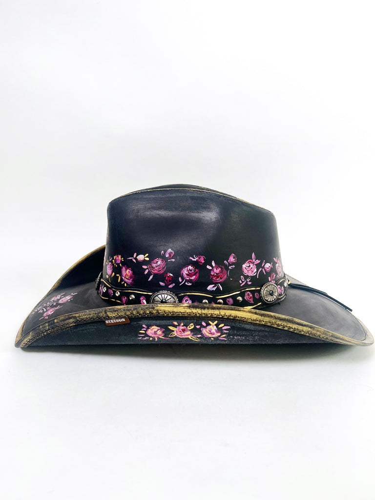Stand out with a custom painted hat. This beauty is covered with elegant, whimsical hand painted, one-of-a-kind roses, buds and metallic gold details.