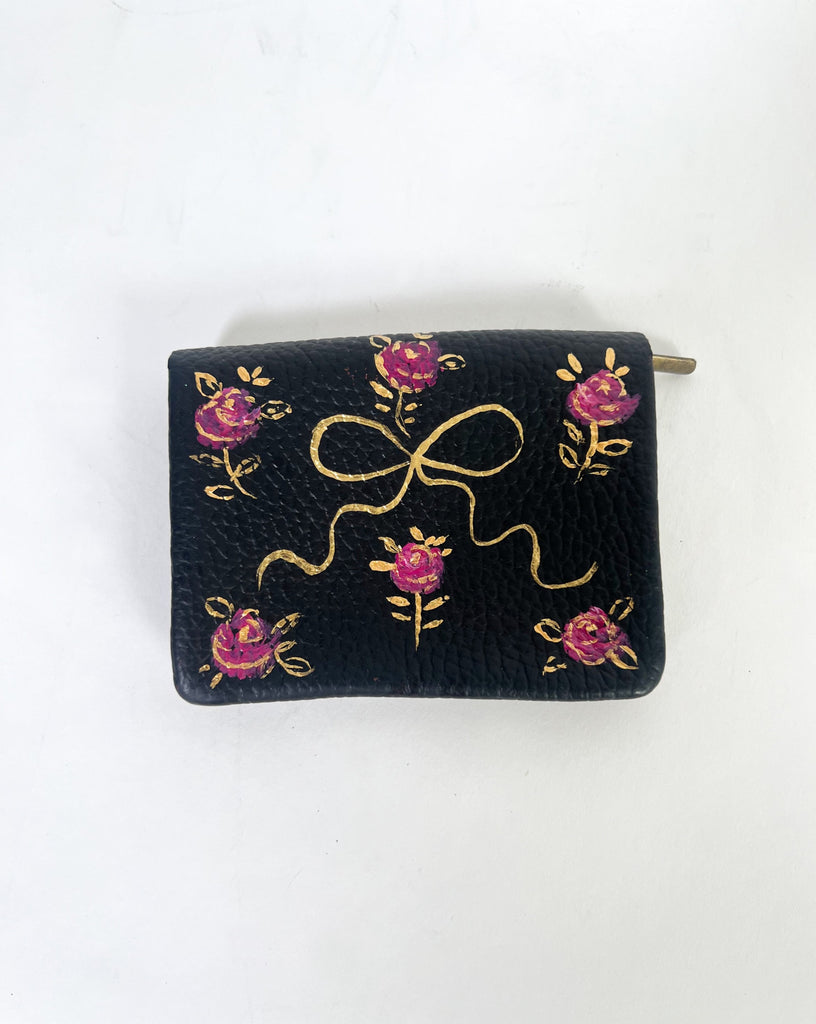 The Rose & Noir wallet is the perfect place to stash your cards, cash & coins. Every time you use it feel all kids of joy with the pretty rose & golden pattern.