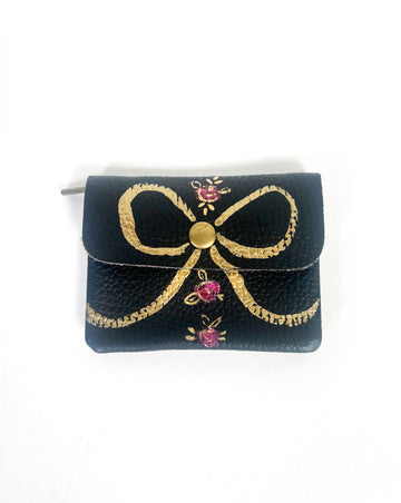 The Rose & Noir wallet is the perfect place to stash your cards, cash & coins. Every time you use it feel all kids of joy with the pretty rose & golden pattern.