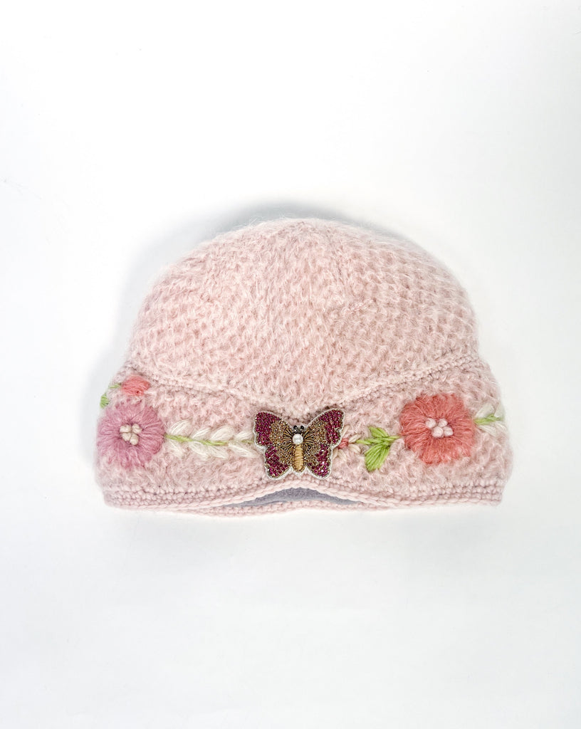 Adeline hand knit cloche hat with pink butterfly brooch.